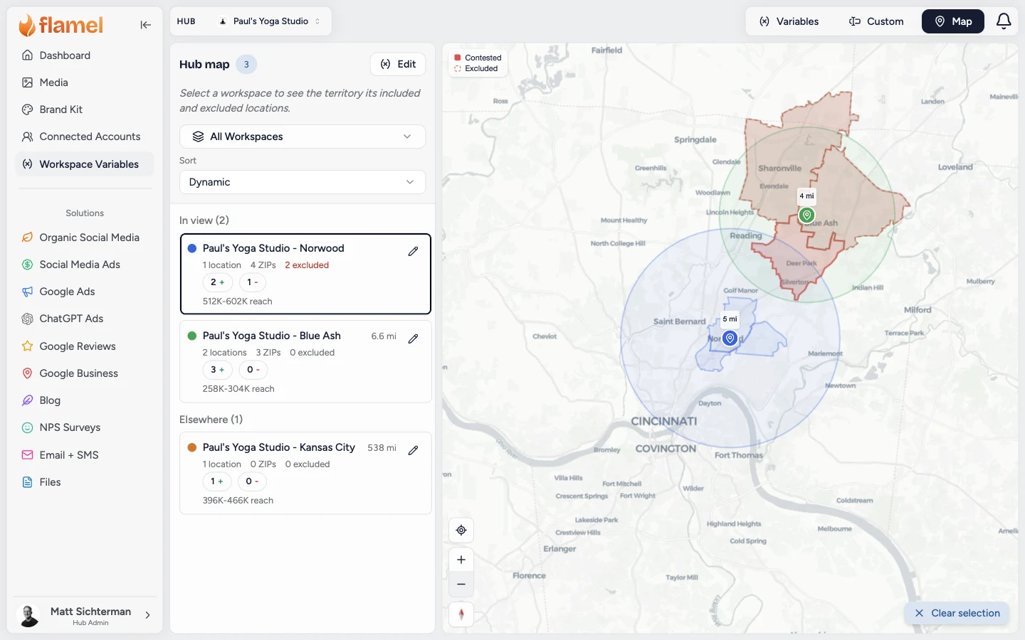 The Map view with one workspace selected, showing its radius and ZIP code territory, a neighbor's radius, a contested ZIP code in solid red, and the neighbor's excluded ZIP codes outlined in dashed red